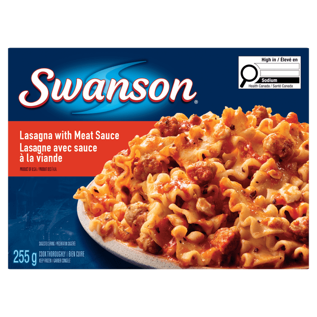 Swanson Lasagna with Meat Sauce frozen dinner showing tender pasta layered with seasoned beef, rich tomato sauce, and melted cheddar cheese on a white plate, displayed on blue packaging with Canadian sodium high content label, suitable for a quick lunch or dinner.