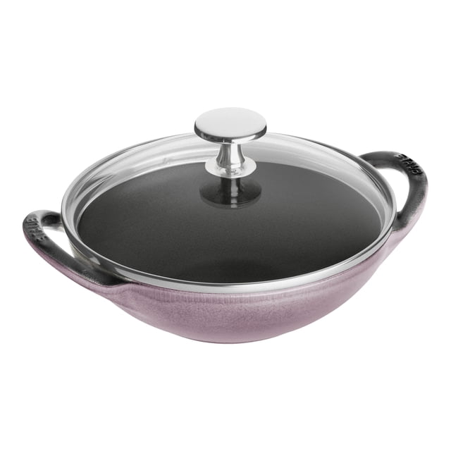 STAUB Specialities 16 cm / 6.5 inch Cast Iron Mini Wok in Cherry Blossom color, featuring a durable enameled cast iron construction with a black matte interior for superior browning and roasting. The wok includes a glass lid with a stainless steel knob and dual side handles for easy handling. Suitable for all heat sources, including gas, electric, and induction, and oven safe up to 500°F. Chip-resistant and dishwasher safe, this French-made wok is ideal for healthy and exotic cooking.