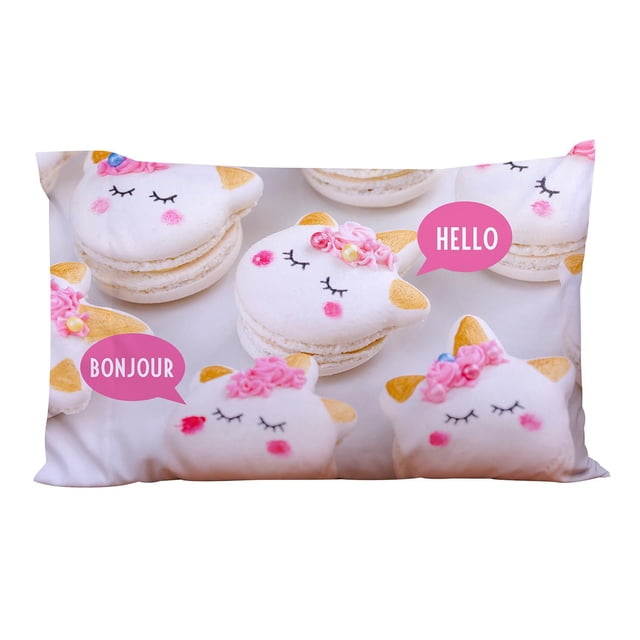 Mainstays Kids Printed Pillowcase 20 by 30 inches featuring a front view of white unicorn-shaped macarons with gold ears, pink cheeks, and closed eyes, decorated with pink floral icing and speech bubbles saying 'HELLO' and 'BONJOUR'. Made of 100% polyester microfiber, suitable for kids' bedding.