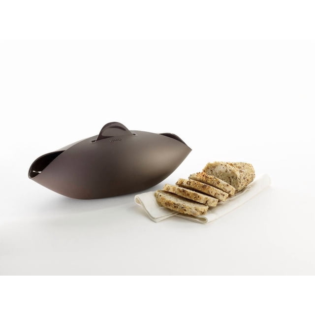 Lekue Mini Bread Maker in matte brown silicone with an oval shape and central handle, shown next to sliced multigrain bread on a white cloth, designed for weighing, kneading, and baking homemade artisan bread quickly and mess-free.