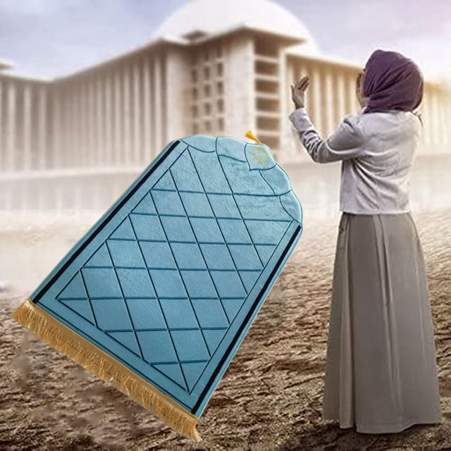 WMQPNNS New Trending Portable Prayer Rug featuring a thick embossed flannel surface with a sponge base for added comfort. The rug showcases a diamond-patterned embossed design in a soft blue tone, complemented by golden fringe at the edges. Lightweight and foldable, it is suitable for both indoor and outdoor use, ideal for prayer or meditation. The background depicts a serene outdoor setting with a person in prayer near a mosque.