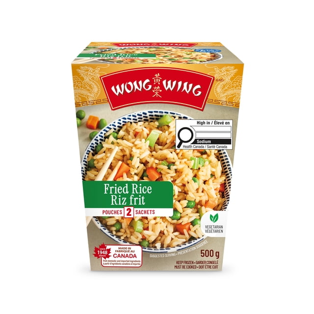 Wong Wing Fried Rice box showing a front view of packaging with a bowl of long-grain rice seasoned with soy sauce and spices, mixed with fresh carrots, green peas, and celery. The 500 g frozen meal contains 2 pouches, is vegetarian, and includes a Health Canada high sodium warning. Made in Canada with domestic and imported ingredients, suitable for a quick heat-and-serve meal.