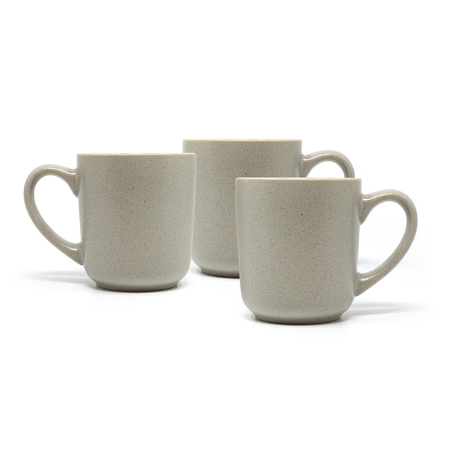 Hometrends Fiona Mug 3 Pack with three beige speckled ceramic mugs, each holding 13 ounces, featuring a matte finish and large handles, arranged staggered on a white background, dishwasher and microwave safe for versatile dining use.