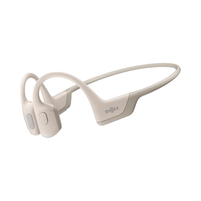 Shokz OpenRun Pro – Premium Bone Conduction Headphones - Mini - Beige shown in a 3/4 front view with a compact open-ear design, flexible beige titanium frame, bone conduction pads near the ears, and visible Shokz logo, ideal for sports and outdoor activities.