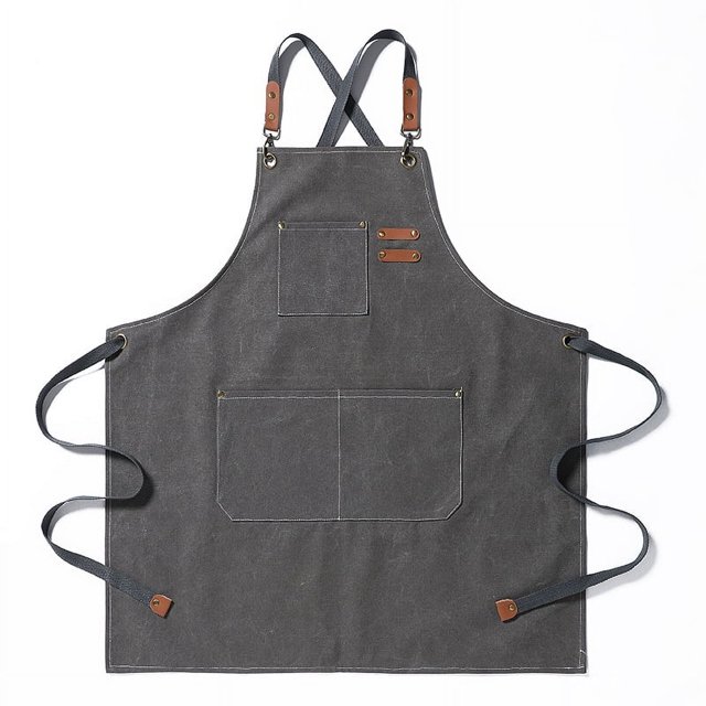 Chef aprons for men and women in grey, crafted from durable cotton canvas with a cross-back adjustable strap design. Includes three reinforced front pockets for holding tools, phones, or accessories. The apron measures 31 inches in length and 26 inches in width, offering full coverage from chest to knee. Suitable for cooking, woodworking, gardening, and crafting.