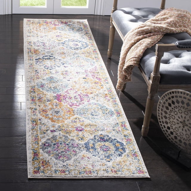 SAFAVIEH Madison Judith Geometric Floral Area Rug 2'3" x 16' runner with a cream base and distressed floral medallion and trellis pattern in muted blue, pink, and yellow tones, power loomed for durability, displayed on dark hardwood floor beside a tufted bench with a knitted throw, ideal for hallways or entryways.