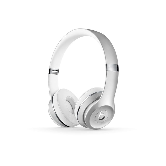 Beats Solo3 Wireless Headphones in white and silver with cushioned on-ear ear cups and adjustable headband, shown in a 3/4 profile. These Bluetooth headphones provide up to 40 hours of battery life and a foldable design, ideal for wireless music and calls.