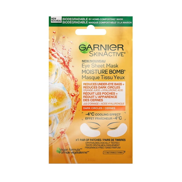 Garnier SkinActive Moisture Bomb Brightening Eye Sheet Mask packaging featuring orange juice splash design, biodegradable home-composting mask with hyaluronic acid, reducing under-eye bags and dark circles, and providing a -4°C cooling effect with a fragrance-free vegan formula.