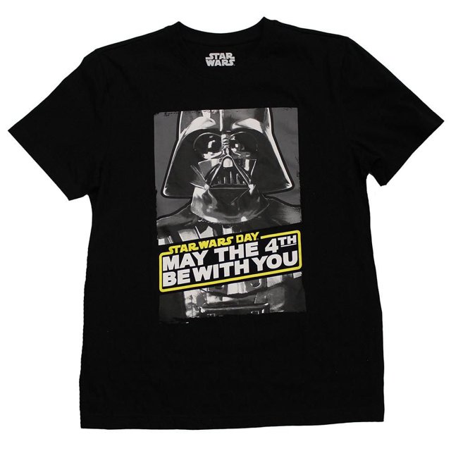 Men's Star Wars T shirt in black with short sleeves and crew neckline, featuring a front graphic print of Darth Vader's helmet in grayscale and the text 'Star Wars Day May the 4th Be With You' in bold yellow and white lettering. This pullover style has a straight hem and pairs well with jeans or joggers.