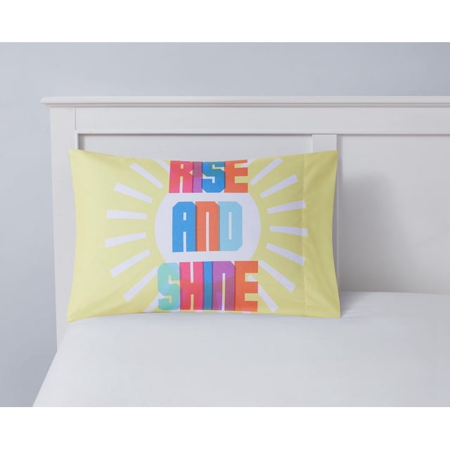 Mainstays Kids Taie d'Oreiller Imprimée en Microfibre de polyester 100 % Jaune, 20 par 30 Pouces, Montrant un Texte Coloré « Lever et Briller » avec des Rayons de Soleil sur un Lit Blanc avec une Tête de Lit en Bois Blanche, Convient pour Égayer les Chambres d'Enfants et Est Souvent Utilisée comme accent Décoratif.