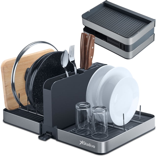 Stelive Foldable Dish Drying Rack with dual parts for kitchen counter space-saving organization, shown in gray. The rack features a detachable six-compartment utensil holder for cutlery, knives, and forks, and a drainage spout to direct water into the sink. Made of rustproof stainless steel and durable plastic, it includes slots for plates, glasses, and cookware. The foldable design enhances countertop space efficiency.