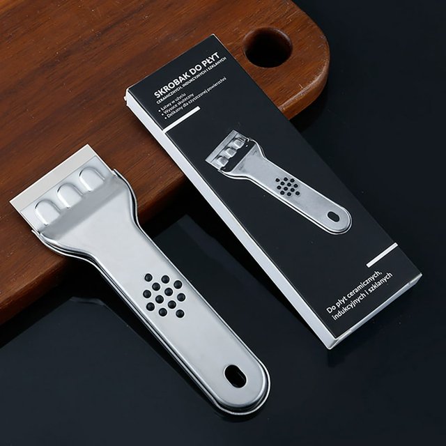 EIMELI Razor Blade Scraper Tool Biplut Cleaning Scraper Set with a polished stainless steel blade and a grey non-slip handle featuring a hanging hole design. The tool is shown on a wooden surface next to its packaging, which emphasizes its suitability for cleaning glass, ceramic, and metal surfaces, including stove tops.