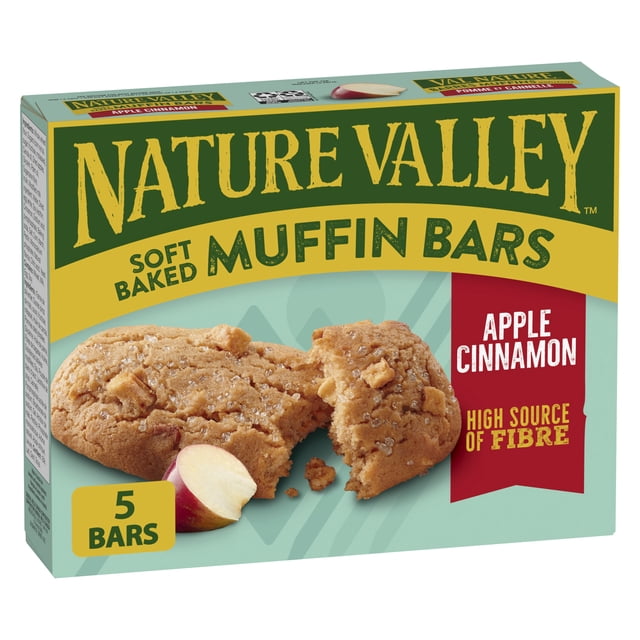 Nature Valley Soft-Baked Muffin Bars Apple Cinnamon snack bars box with five bars, featuring a close-up of a broken soft muffin bar with apple pieces and a sliced apple, highlighting its high fibre and whole grain content, ideal as a portable snack.