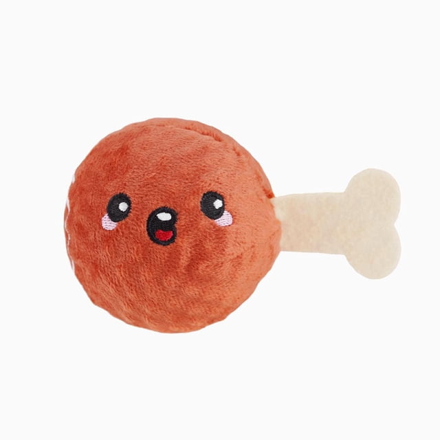 Hugsmart Ham Dog Ball Toy, a plush dog chew toy shaped like a ham with a soft reddish-brown round body and beige bone-shaped handle, featuring embroidered eyes and mouth, suitable for interactive fetch and chew play.