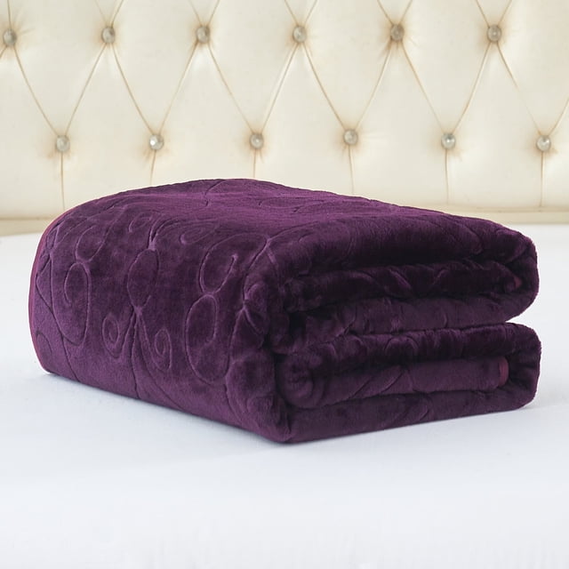 JML Warm Fleece Blanket, 1 Ply Lightweight Embossed Bed Blanket in Queen size (75"x 91"), shown in a rich purple color with an embossed swirl pattern. Made from 100% polyester, this plush microfiber blanket offers softness and warmth, ideal for beds, couches, or recliners. Lightweight and machine washable for easy care, it features reinforced stitching and fray-resistant edges for durability. Displayed folded on a white bed with a tufted cream headboard in the background.