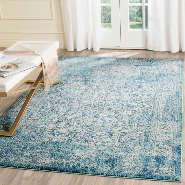 Safavieh Evoke Trena Traditional Area Rug in blue and cream with a distressed vintage pattern, made of soft, durable polypropylene frieze pile, displayed on light hardwood flooring near a white bench with gold legs and sheer white curtains, ideal for adding casual style and comfort to living areas.
