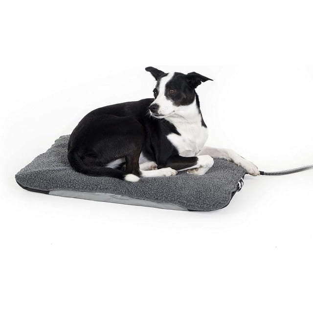 K&H Lectro-Soft Outdoor Heated Dog Bed Medium Gray with a black and white dog resting on a soft orthopedic fleece surface, featuring a waterproof PVC base and a thermostatically controlled steel-wrapped power cord, ideal for outdoor pet comfort.