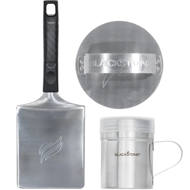 Blackstone 3-Piece Press & Sear Burger Kit with a heavy gauge stainless steel wide hamburger spatula featuring a black textured handle, a round stainless steel burger press with an engraved Blackstone logo hand strap, and a stainless steel spice dredge container with a clear lid, suitable for outdoor BBQ cooking and burger preparation.