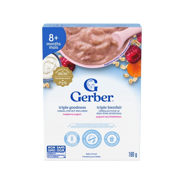 Gerber Triple Goodness Raspberry Yogurt Baby Cereal for babies 8 months and older, front-facing box with a pink spoon holding smooth raspberry yogurt cereal, promoting gut wellness with probiotic B. lactis, real yogurt, fibre-rich ingredients, excellent source of iron and B vitamins, non-GMO, 180 g.