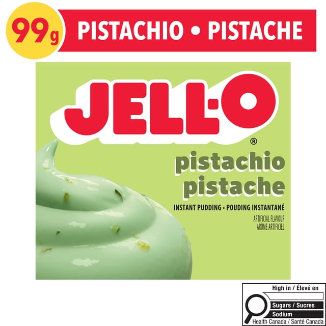 Jell-O Pistachio Instant Pudding Mix 99g box with light green background featuring a swirl of pistachio pudding with visible nut pieces, labeled in English and French, casein-free and ideal for quick dessert preparation.