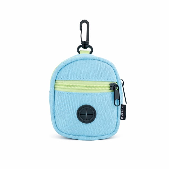 One Paw Poop Bag Dispenser and Snack Holder for Dogs in light blue polyester with pale green zipper, black clip for leash attachment, and front circular waste bag dispenser opening, ideal for dog waste and treat storage during walks.