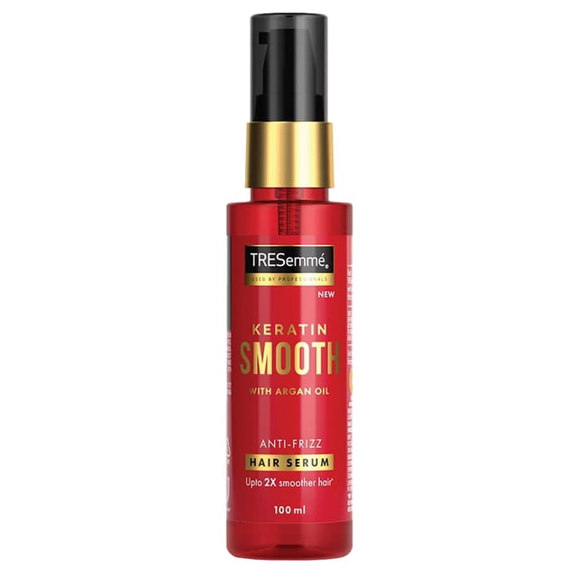 Tresemme Keratin Smooth Anti-Frizz Hair Serum 100ml in a red bottle with a black pump dispenser and gold accents. The label highlights its keratin and argan oil formula for up to 2x smoother hair and 48-hour frizz control. Ideal for medium to thick or curly hair.
