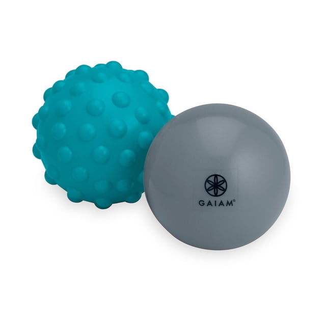 Gaiam Restore Hot & Cold Therapy Kit with two therapy balls, one smooth grey ball featuring the Gaiam logo and one teal textured ball with raised nodules, designed for muscle tension relief and improved circulation in fitness recovery.