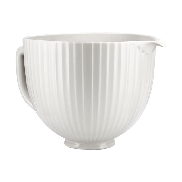 KitchenAid® 5 Quart Classic Columns Ceramic Bowl in white with vertical ribbed texture, featuring a handle and pour spout, made of titanium-reinforced ceramic that resists chipping and staining, compatible with 4.5 and 5 quart tilt-head stand mixers, freezer, microwave, dishwasher, and oven safe up to 475°F, also suitable for softening butter or tempering chocolate.