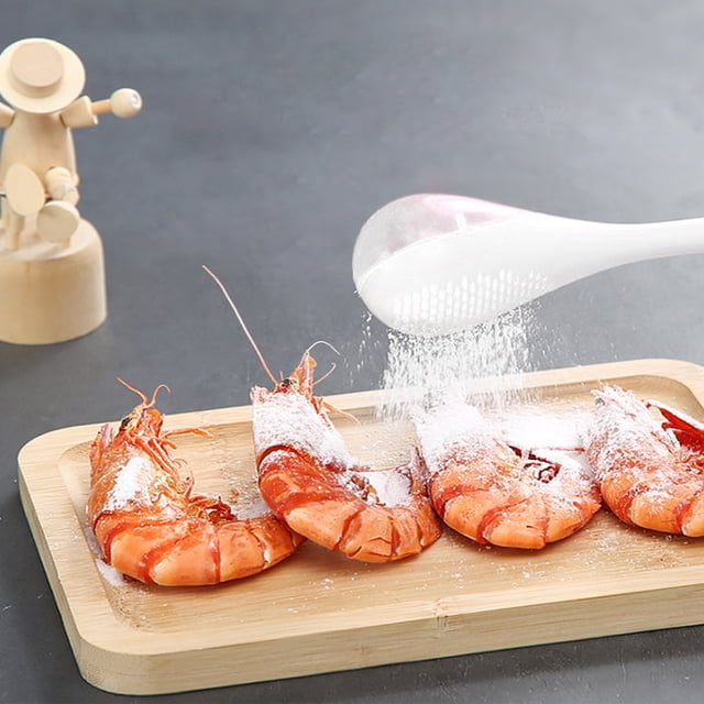 TIMIFIS Flour Dispenser Powdered Sugar Shaker Duster, a white plastic kitchen gadget for dusting powdered sugar, flour, or spices. The image shows the shaker sprinkling powdered sugar over shrimp on a wooden tray, ideal for baking or food preparation. Features include a perforated wand for even distribution and a solid side for resting on counters, suitable for kitchen organization and food storage.