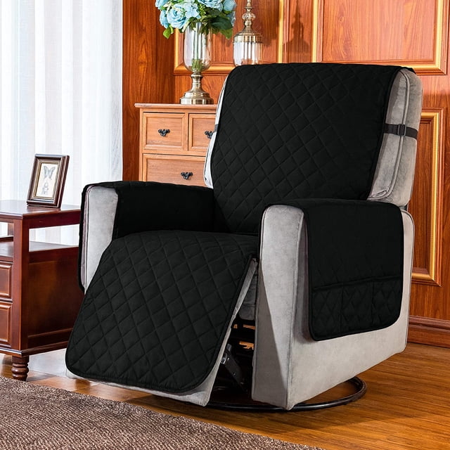 Subrtex Reversible Recliner Chair Cover Washable Furniture Protector in black, displayed on a recliner in a cozy living room. The cover has a quilted pattern, adjustable elastic straps for stability, and a side pocket for convenience. Crafted from 100% microfiber fabric, it is soft, durable, and shields furniture from spills, stains, and pet hair. Available in small (25-inch seat width) and large (28-inch seat width) sizes.