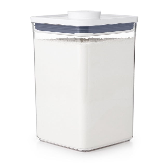 OXO Softworks POP Big, Square, Medium 4.2L food storage container with clear BPA-free plastic body and white airtight lid featuring a gray silicone seal and pop-up button, filled with white powder, ideal for stackable kitchen and pantry organization, also suitable for storing dry goods like flour or sugar.