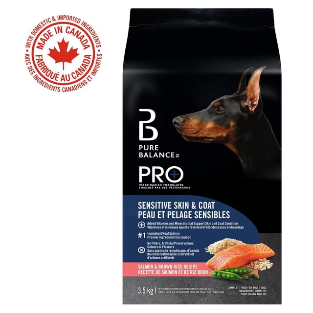 Pure Balance Pro+ Sensitive Skin & Coat Salmon & Brown Rice Recipe dry dog food bag showing a black and brown Doberman side profile on a black background, highlighting real salmon as the first ingredient, added vitamins and minerals for skin and coat health, no fillers or artificial additives, weighing 3.5 kg, with images of salmon, brown rice, and green peas, and a red maple leaf seal indicating made in Canada with domestic and imported ingredients.