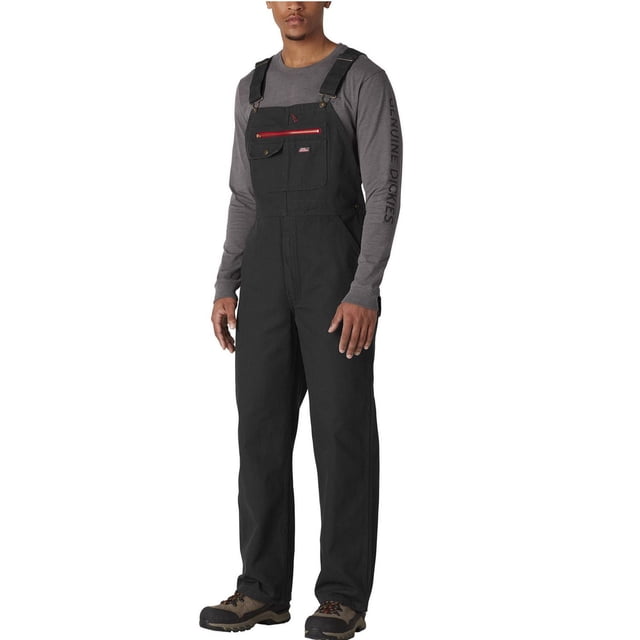 Genuine Dickies Bib Overall in black durable cotton denim with multi-compartment chest pockets including a red zipper pocket, hammer loop, adjustable shoulder straps, and large back pockets, shown worn over a grey long-sleeve shirt with 'Genuine Dickies' text on the sleeve, designed for utility and durability in workwear.
