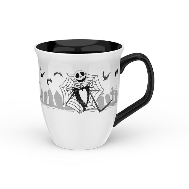 Zak Designs The Nightmare Before Christmas 15oz ceramic mug with white exterior, black interior and handle, featuring Jack Skellington in a spider web with bats and gravestones, microwave and dishwasher safe, ideal for hot beverages or soup.