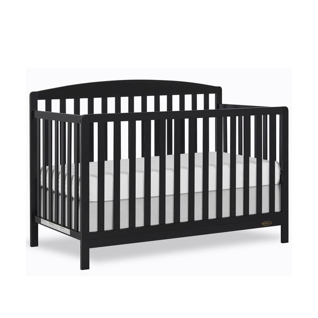 Dream On Me Odelle 5 in 1 Convertible Crib front-facing white wooden crib with vertical spindles and panel headboard. Three adjustable mattress heights; converts to daybed, toddler bed and full bed (conversion kit sold separately). Made from New Zealand pinewood; available finishes White, Pebble Grey and Matte Black. Product dimensions 54.72" L x 29.33" W x 40.16" H (139 x 74.5 x 102 cm).