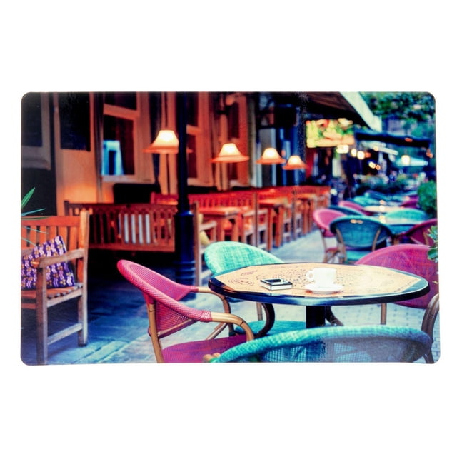 Plastic Placemat (European Bistro) - Set of 12 with a rectangular design featuring a European bistro print of an outdoor café scene showing red and teal woven chairs around a round table with a cup and book, set on stone pavement with warm street lamps and wooden benches, suitable for indoor and outdoor dining.