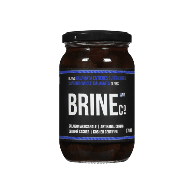 Brine Co Whole Kalamata Olives 370ML Jar with a clear glass jar and black lid, containing dark almond-shaped Kalamata olives in brine. The black label displays white and blue text highlighting artisanal curing, kosher certification, and Greek olives suitable for pantry food and enhancing Greek salads.