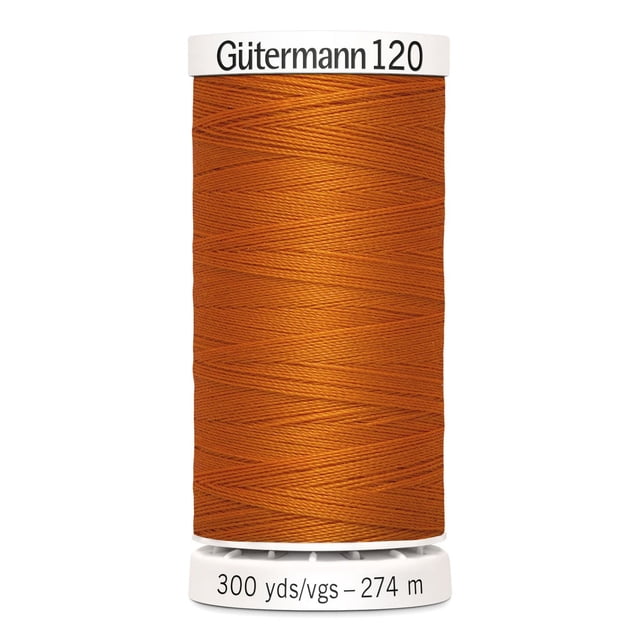 Gutermann 120 100% polyester all purpose thread spool in burnt orange color, tightly wound on a white plastic spool labeled with 300 yards (274 meters), suitable for machine and hand sewing woven, knit, and synthetic fabrics, also ideal for craft and mending projects.