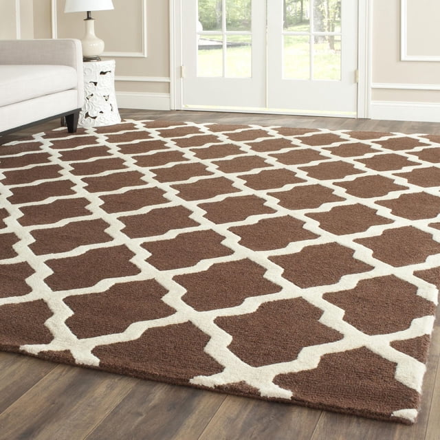 Safavieh Cambridge Liam Geometric Area Rug with brown and cream geometric trellis pattern, hand-tufted wool texture, displayed on hardwood floor in a bright living room, ideal for adding modern American style and texture to home decor.