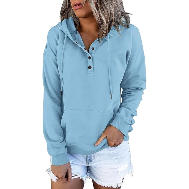 EQWLJWE Womens 2023 Hooded Snap Button Collar Drawstring Hoodies Pullover Sweatshirts in a light blue shade. This plus-size, oversized sweatshirt features a hood with drawstrings, a snap button collar, long sleeves, and a front pocket. Designed for casual fall wear, it is shown paired with white denim shorts.