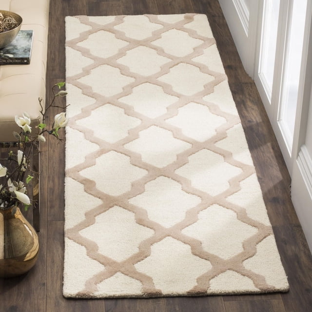 Safavieh Cambridge Liam Geometric Area Rug with a beige lattice pattern on cream hand-tufted wool, placed on dark hardwood flooring in a hallway with white molding, suitable for adding texture and warmth to home or office spaces.