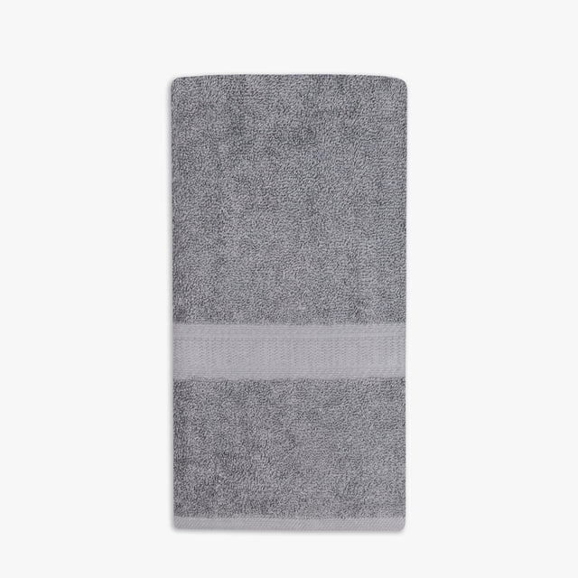 Mainstays Basics Solid Hand Towel in grey, folded flat showing cotton terry texture and a woven band near one edge, measuring 16 by 26 inches, soft and absorbent for daily bathroom use, often used as a versatile cleaning cloth.