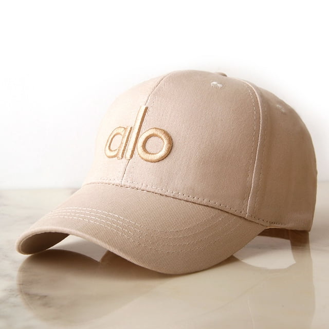 Yoga Hat For Women Men Stylish Baseball Cap in a light brown shade with an embroidered 'alo' logo on the front panel. Crafted from a soft blended fabric, this one-size-fits-most cap is suitable for yoga and outdoor activities. It features a curved brim and an adjustable strap for a secure fit. A thoughtful gift for fashion lovers.