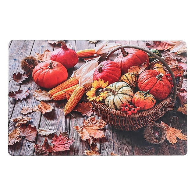 Plastic Placemat (Happy Harvest) - Set of 12 with an autumn harvest design featuring a wicker basket filled with small pumpkins, gourds, a sunflower, and red berries, surrounded by dried corn cobs and fall leaves on a wooden surface, suitable for dining table use.