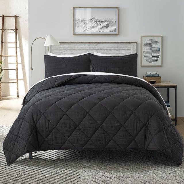 JML 2 Pieces Black Twin Comforter Set, a soft microfiber bedding set with quilted pleated square patterns, designed for all seasons. Made of 90GSM brushed microfiber and filled with 250GSM polyester for a total of 430GSM, providing warmth and comfort. Includes one comforter and one pillowcase, shown on a neatly arranged bed in a modern bedroom with neutral decor.