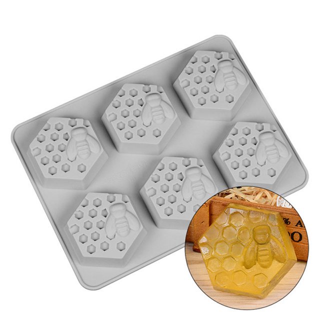 LSLJS Silicone Baking Molds Silicone Mould with 6 honey bee design cavities, made of food-grade silicone. The mold features hexagonal shapes with intricate honeycomb and bee details, suitable for making soap, wax, chocolates, or baked goods. The mold is shown in a neutral color with a close-up of a finished honey bee soap in yellow. Dimensions are approximately 24.5 x 18.3 x 2.8 cm.