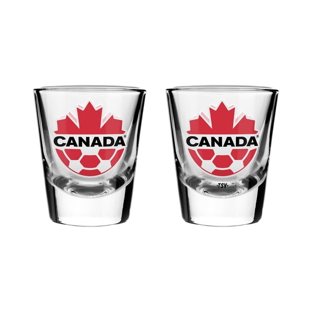 2pk SHOT GLASS CANADA SOCCER with two clear 2-ounce shot glasses featuring a solid base and bright red maple leaf and soccer ball logo above CANADA text in black, packaged in a gift box, dishwasher safe, ideal for anniversary party tableware and gifting loyal sports fans.