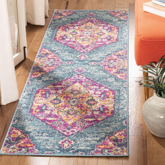 SAFAVIEH Madison Karissa floral area rug featuring a blue base with vibrant pink, yellow, and purple hexagonal floral motifs on hardwood floor next to an orange sofa