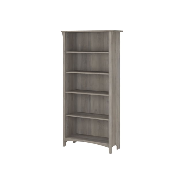 Bush Furniture Salinas Tall bookcase with 5 shelves in driftwood gray finish. The tall design features three adjustable shelves and two fixed shelves for flexible storage and stability. Inspired by Mission-style, it includes tapered legs and curved base rails, suitable for living rooms or home offices. Each shelf supports up to 50 pounds, ideal for books, decorations, and photos.