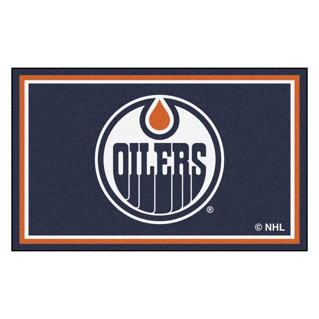 NHL-Edmonton Oilers 4x6 Rug with a navy blue background bordered by white and orange stripes, featuring the Edmonton Oilers logo centered with a white circle, navy blue 'OILERS' text, and an orange oil drop. Made of 32 oz. nylon with non-skid latex backing, ideal for game rooms or offices and easy to clean with regular vacuuming.